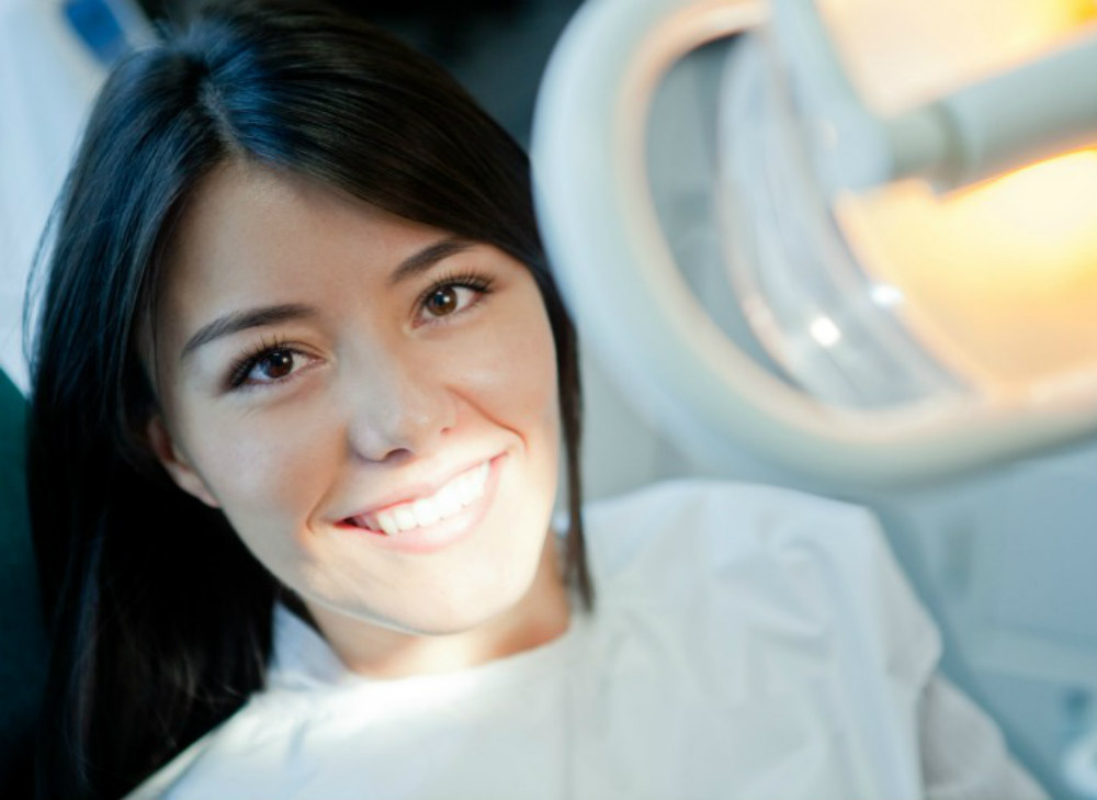 Young woman portrait visiting the dentist and smiling