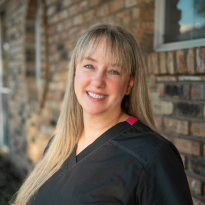 Chris, Hygiene Coordinator at our Plano dental office, wearing a bright and welcoming smile.