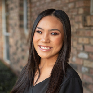 Stacie, Dental Hygienist at our Plano dental office, radiating warmth with her cheerful smile.