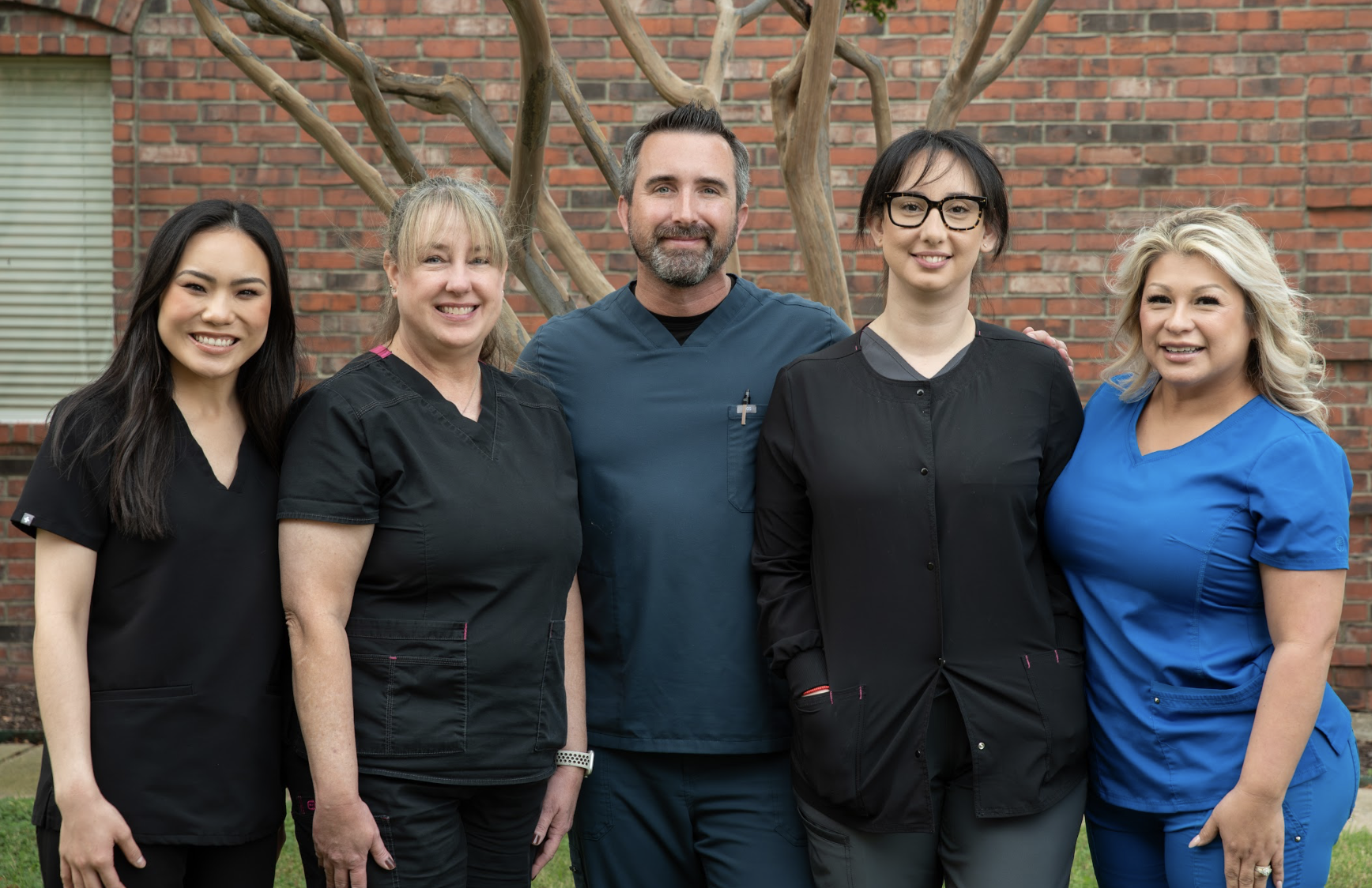 dental patient smiling while getting ready for an xray